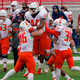 Illinois linebacker Tarique Barnes (44) celebrates with teammates after he intercepted a pass.